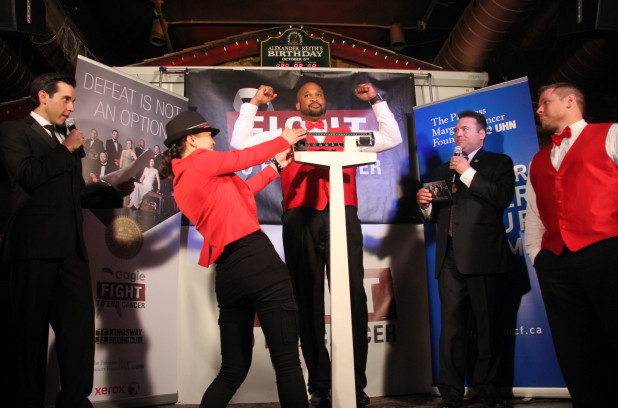 Andrew Young flexes while competitor Derek Van Doorn, right, looks on. They will compete in the heavyweight bout of the 2014 Fight to End Cancer. Photo Credit:  Metro / Jessica Smith Cross