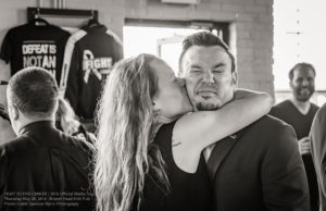 Craig Lauzon, FTEC2016 Main Event Fighter, receiving a supportive kiss from Erica McMaster of the FTEC2015 fight team Photo Credit: Spencer Wynn