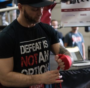 Jeff MacWilliams (FTEC2015 Fighter) wraps his hands in preparation for his training session Photo Credit: Rebecca Freeman