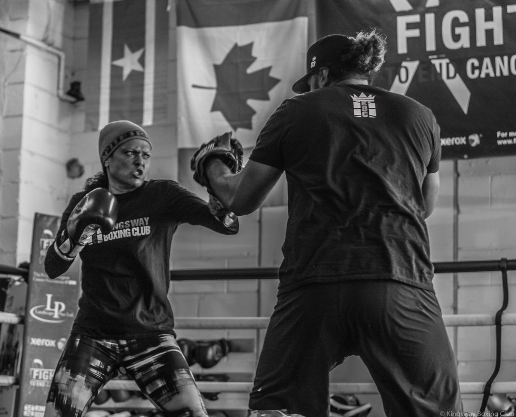 Shireen puts in the work on the pads with her coach Virgil. Photo Credit: Jennifer Huggins